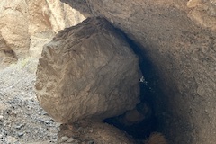 rock wedged in a canyon wall 